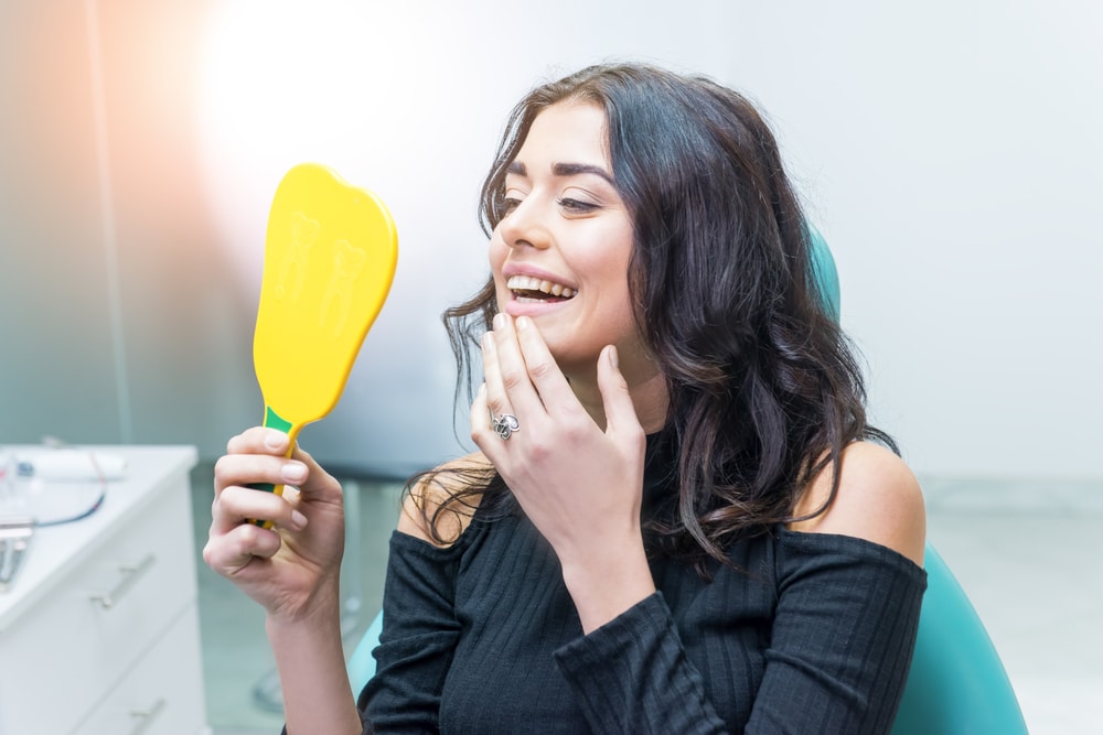 Woman,Looking,At,Her,Teeth.,Smiling,Lady,At,Dentist,Office.